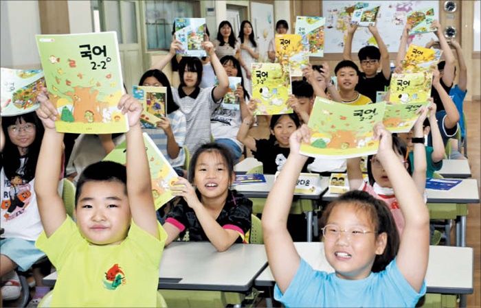 지난해 8월 부산의 한 초등학교에서 학생들이 교과서를 들고 웃고 있어요.
/김동환 기자